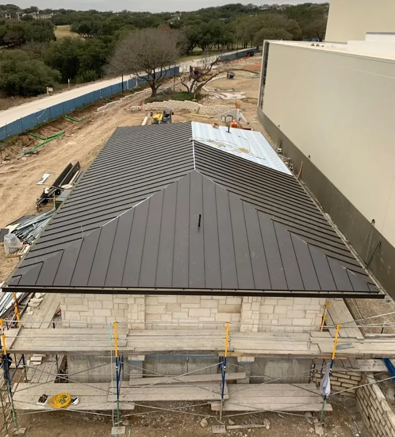 Metal roof new construction with scaffolding in Rogers